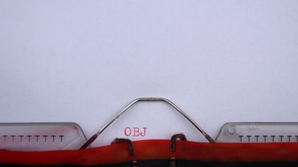 Objectives - word printed on an old typewriter in red letters, close up. vintage inscription