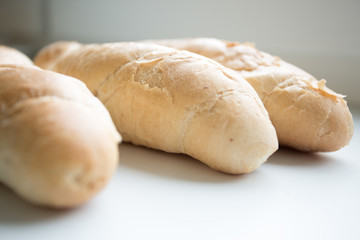 fresh bread rolls on a plate isolated on white