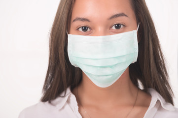 COVID-19 Pandemic Coronavirus Woman wearing face mask protective for spreading of disease virus SARS-CoV-2. Girl with surgical mask on face against Coronavirus Disease 2019.