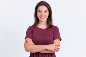 Fototapeta premium Portrait of happy young beautiful woman smiling with arms crossed