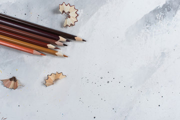 Brown pencils on a white stone table