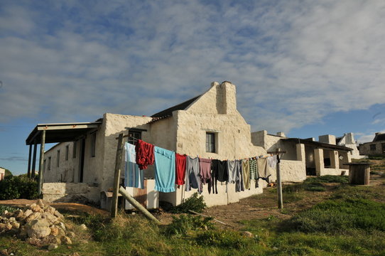 old fisherman's cottage with brightly colored washing on a line