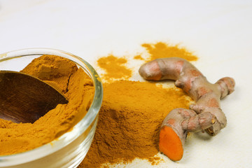 Turmeric powder and fresh turmeric roots isolated on a white background are ingredients in turmeric foods and ingredients in skin care products. Turmeric helps the skin to be strong.
