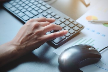 The hand of Asian woman is press, typing on keyboard 2 language is Thai and English of computer. Maybe preparation about information to report, chat to lover or shopping on line by connect to internet