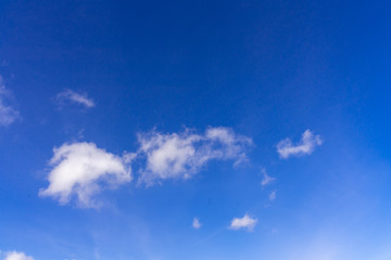 saturated blue sky with small pile clouds