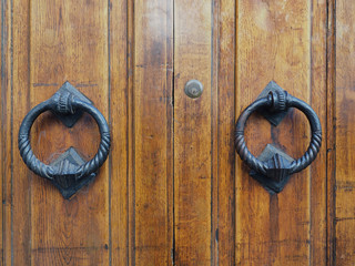 Italian wooden door, detail. Round handles.
