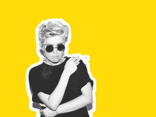 Stylish fashion magazine in the style of a collage. Sexy blonde bad girl in a black t-shirt and rock sunglasses with a cigarette in his hand. Black and white image yellow background.
