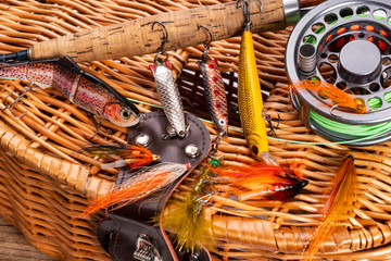 different fishing tackle on wooden background