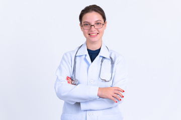 Portrait of young happy woman doctor smiling with arms crossed