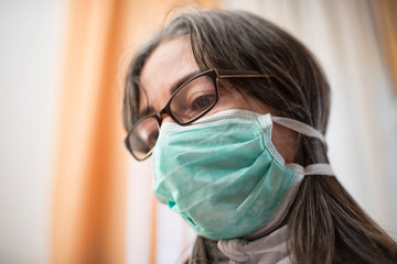 sick woman of corona wears a protective mask