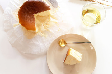 Basque Burnt Cheesecake set on white table background. Overhead shot. 