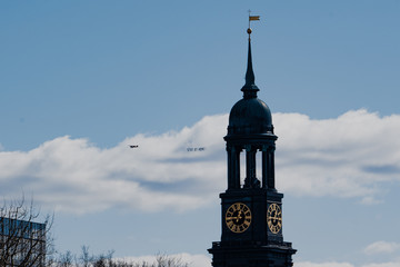 Hamburg, Germany - March 21, 2020; #StayAtHome sign pulled by an airplane flying above the city...