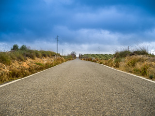 Fototapeta na wymiar Small asphalt road in the countryside