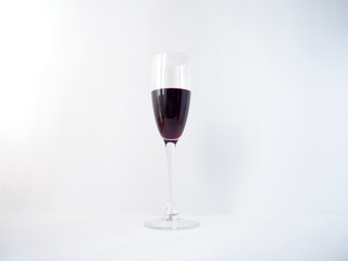 Red wine in a glass on white background