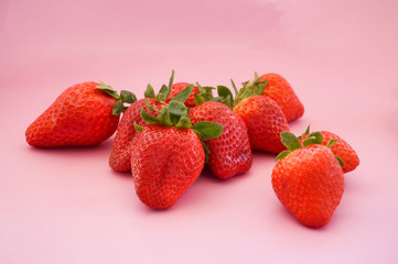 Fresh juicy strawberries on pink background