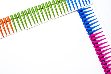 Frame of multi- colored hair clips on a white background, space for inscriptions, copy of the space