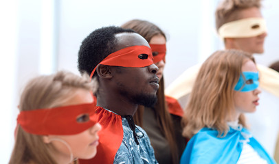 serious superhero girl standing with her friends. © ASDF