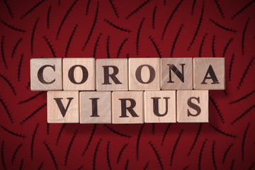 Dark brown red background with scars and with wooden cubes spelling coronavirus on it. 2019 - 2020 Novel Coronavirus (2019-nCoV) concept, for an outbreak occurs of covid-19.