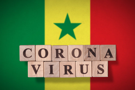 Flag of Senegal with wooden cubes spelling coronavirus on it. 2019 - 2020 Novel Coronavirus (2019-nCoV) concept, for an outbreak occurs in Senegal.