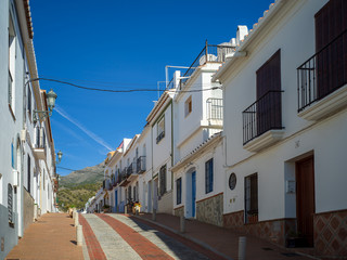 Fototapeta na wymiar Narrow street in small Spanish town in Nerja, Costa del Sol, Spain