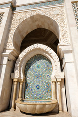 Traditional Tap Wall Fountain decorated with colorful shapes of mosaic, Hassan II Mosque in...