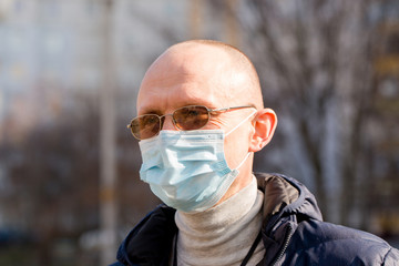 A man in a protective mask walks