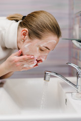 Coronavirus prevention. Wash face with antibacterial soap and running water in sink. Washing face. Epidemic Covid-19. Coronavirus prevention body hygiene. Flu disease.