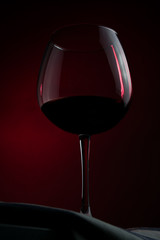 glass of french wine on a red background.
