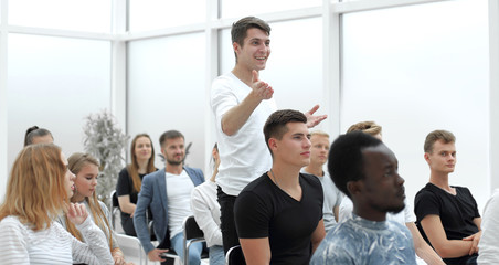 Fototapeta premium young man asks a question at a business seminar