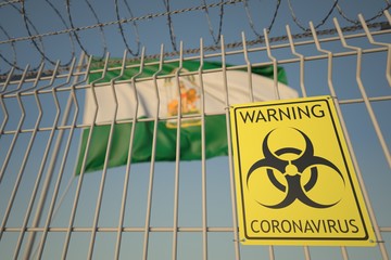 Coronavirus warning sign on the barbed wire fence near flag of Andalusia, an autonomous community in Spain. COVID-19 quarantine related 3D rendering