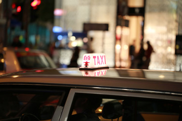 taxi  and chinese word taxi on the cab light box in hong kong with the blur background