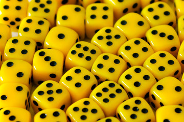 The dice are yellow. Playing a game with dice. Rolling the dice concept for business risk. Risk concept.