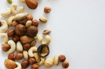 Nuts on black background, top view with copyspace. Assorted mixed nuts   on white table.