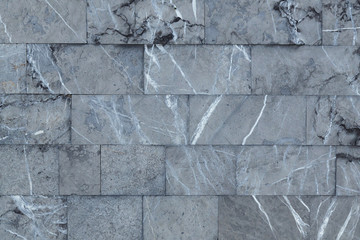 Marble wall blocks. Grey white black natural stone texture background with cracks