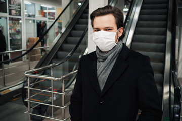 Concept 2019-nCoV coronavirus. Man wearing a medical mask to protect against the COVID-19 pandemic
