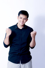 A Portrait of young asian man wearing Black Shirt showing gesture sign or devices