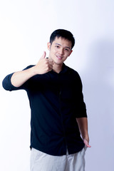 A Portrait of young asian man wearing Black Shirt showing gesture sign or devices