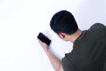 A Portrait of young asian wearing a green T-shirt take rest and using smartphone or laptop