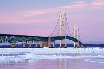 Winter landscape near sunset of the Mackinac Bridge and the frozen Straits of Mackinac, Michigan's Upper and Lower Peninsulas, USA