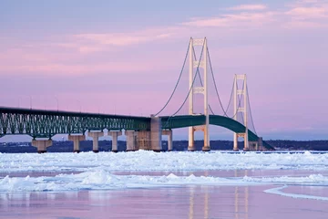Winter landscape near sunset of the Mackinac Bridge and the frozen Straits of Mackinac, Michigan's Upper and Lower Peninsulas, USA