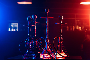 hookahs with shisha charcoals in bowls on the table in the restaurant for traditional Arabic...