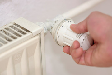male hand adjusts battery temperature controller