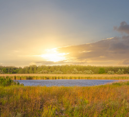 small lake among a prairies at the sunset, outdoor evening scene