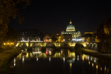 Fototapeta na wymiar Night scene of Rome, Tevere river with basilica in background