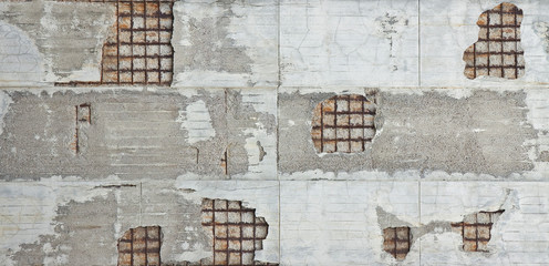 Old reinforced concrete structure with damaged and rusty metallic reinforcement