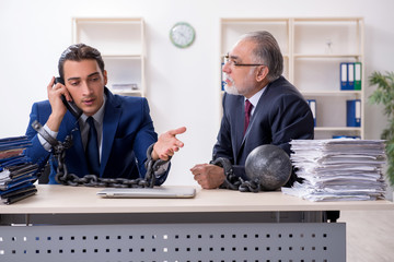 Two male employees unhappy with excessive work