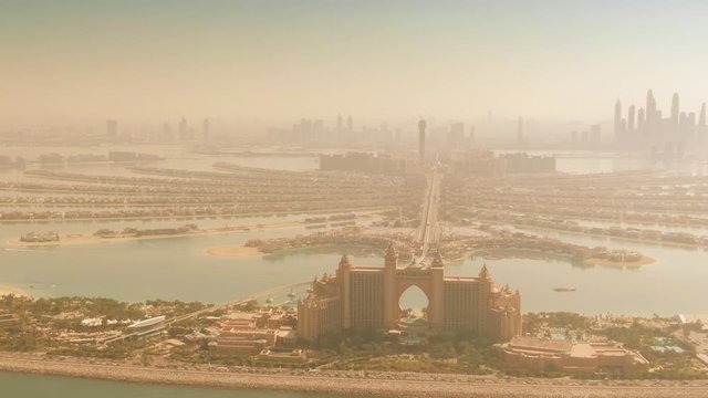 Aerial dolly zoom shot of the Palm Jumeirah island and distant Dubai's skyline, UAE