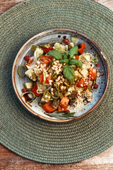 Salad with pine nuts and tomatoes. Vegetarian vegetable salad. European cuisine.