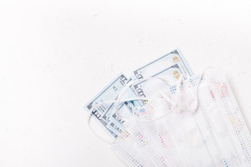 children's medical masks with a picture, protection against coronavirus, a stack of dollar bills, mask shortages, quarantine, world pandemic 2020