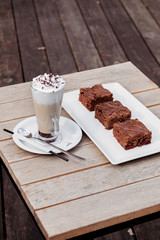 Chocolate cake with cherry and latte.